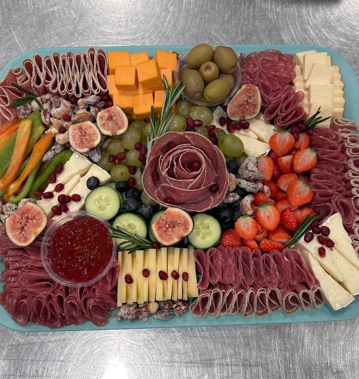 Charcuterie board with brie, meats, fruits and crackers