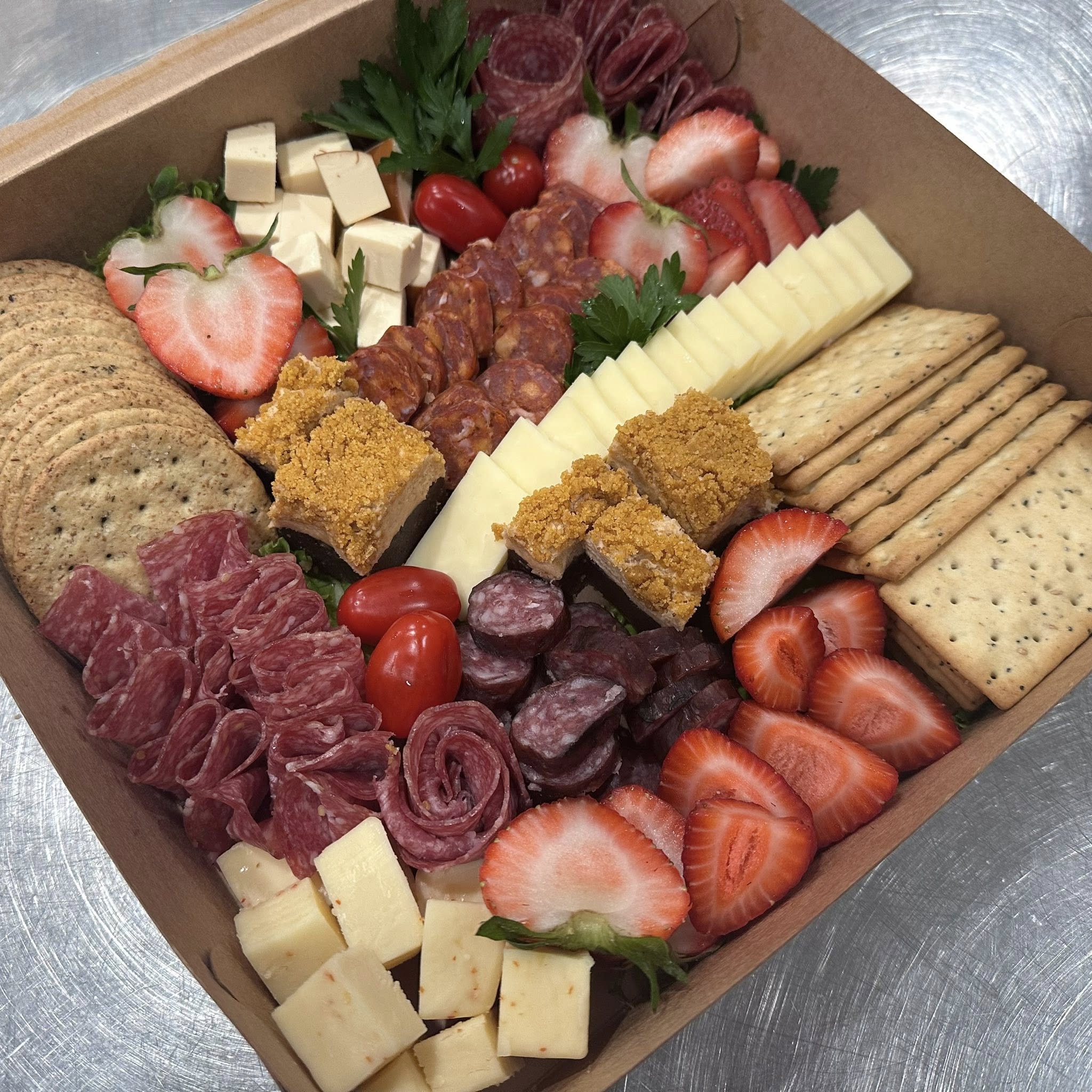 Charcuterie box with meats, cheese and strawberries